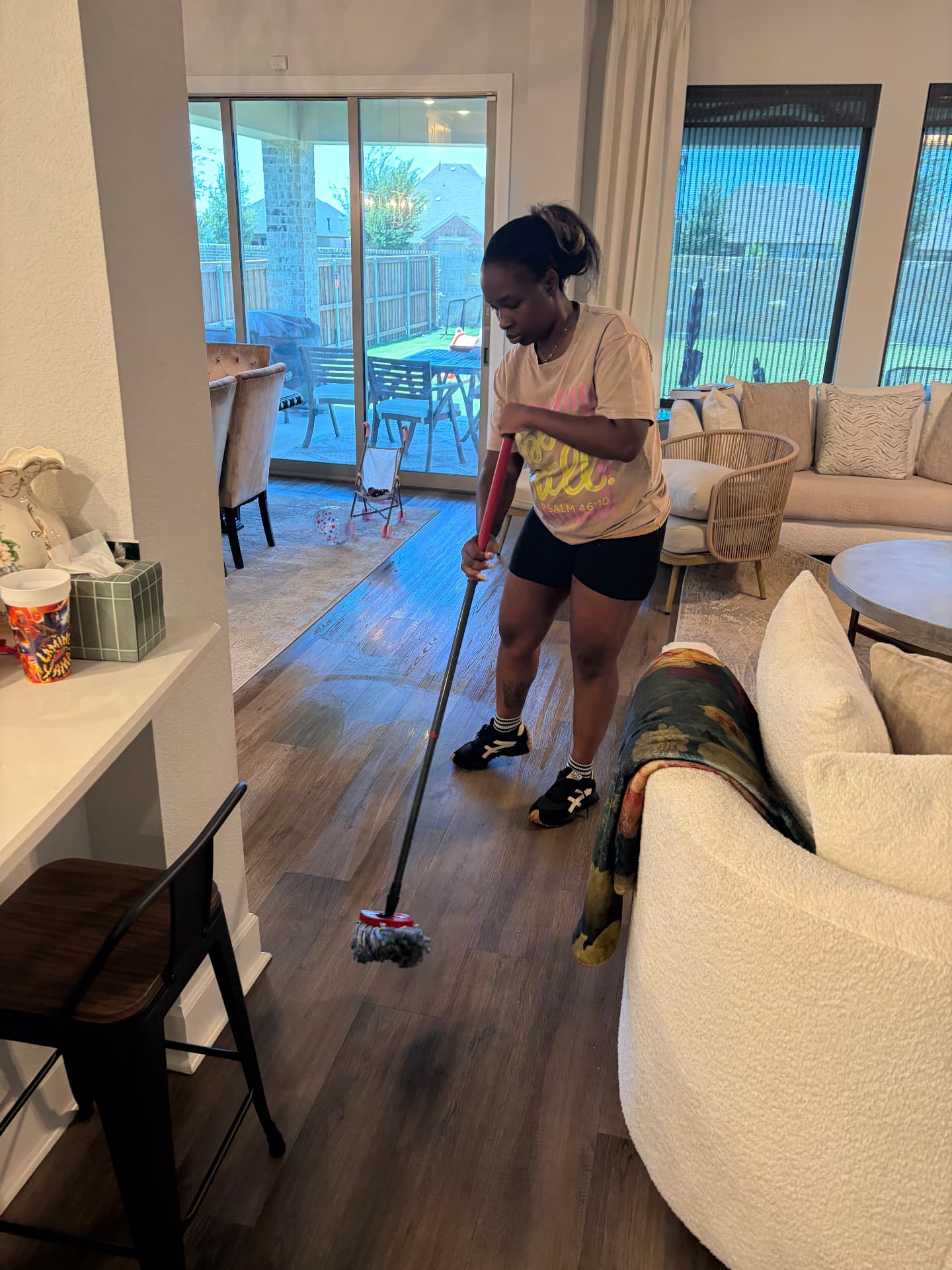Forever Family cleaner mopping hardwood floors in a Dallas living room